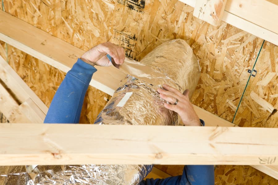 Man-Insulating-An-Attic Man Insulating An Attic
