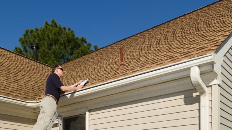 Person Inspecting Roof