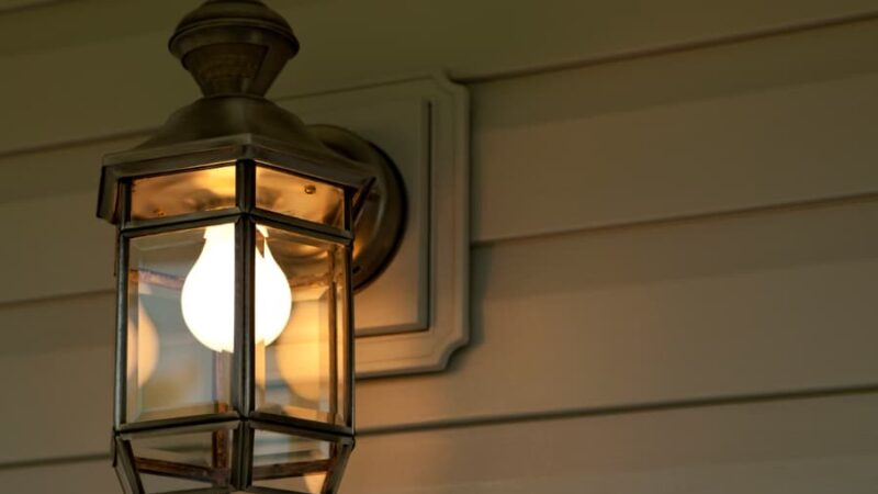 Wall Sconce On Vinyl Siding At Night