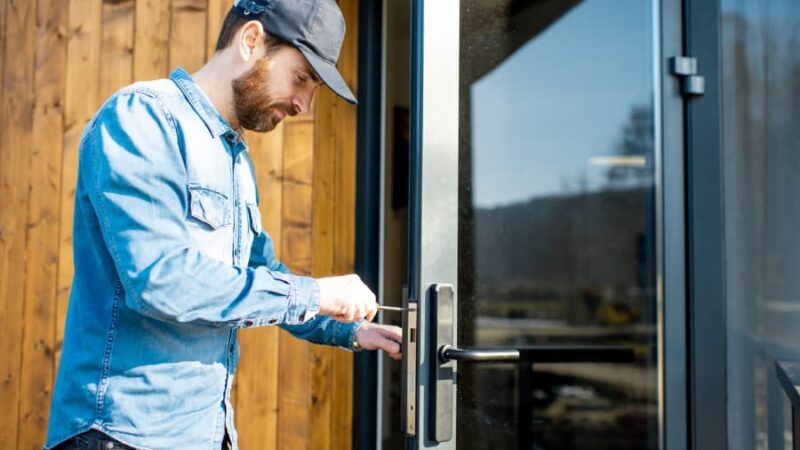 Contractor replacing door lock