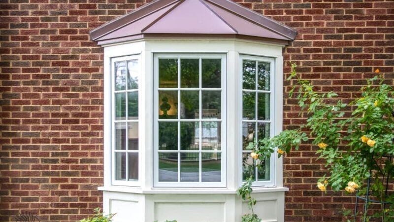 White bay window on brick wall