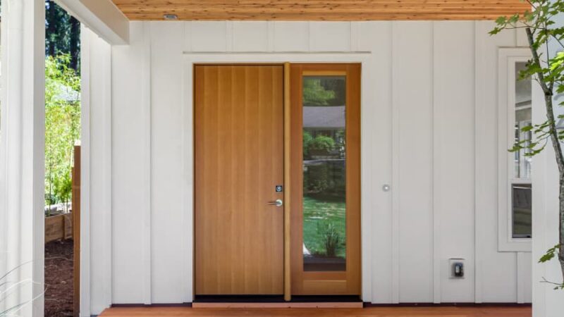 Entryway of home with white board and batten siding