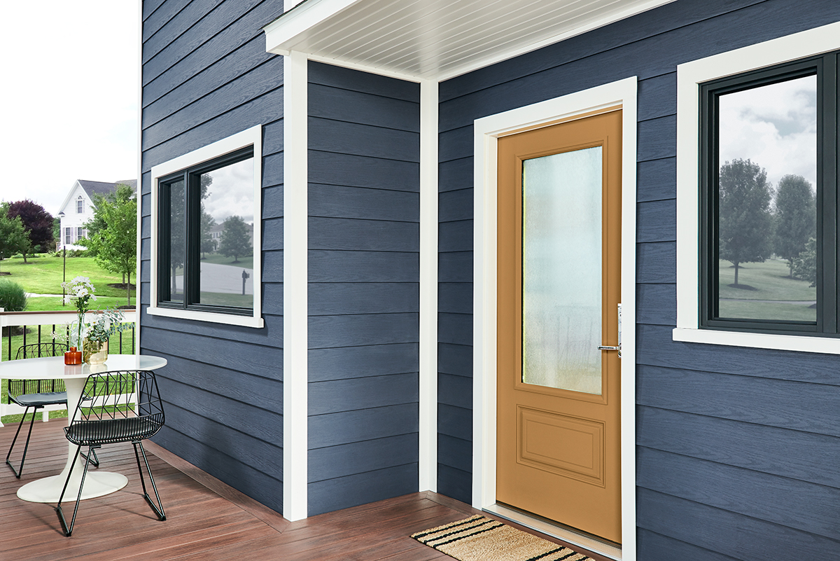 Wolf-Portrait-Blue-Back-door Moden home with blue siding.