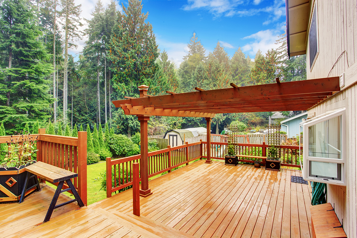 Spacious,Wooden,Deck,With,Benches,And,Attached,Pergola Spacious wooden deck