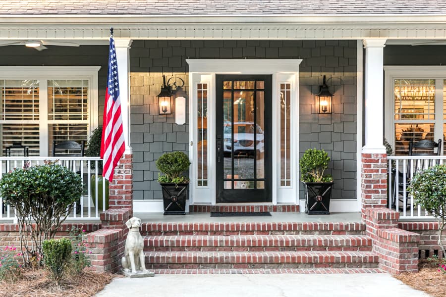 The-front-door-of-a-large-home. Extravagant entryway with steel and glass storm door.