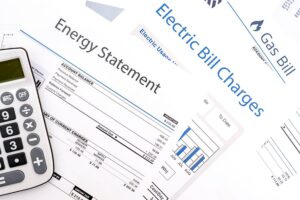Energy bills next to a calculator on a table
