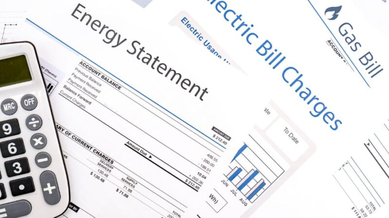 Energy bills next to a calculator on a table