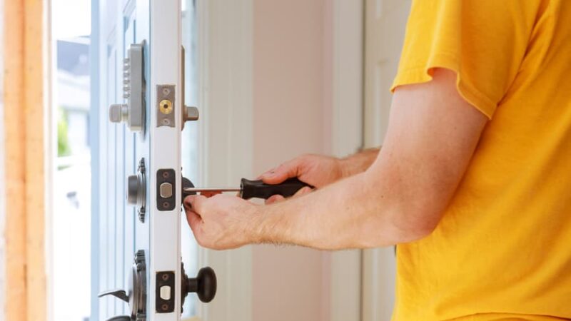 Exterior door technician installing replacement entryway door