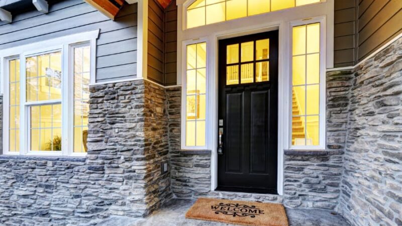 Front covered porch design with stone columns
