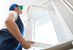 Handyman installing casement window in home