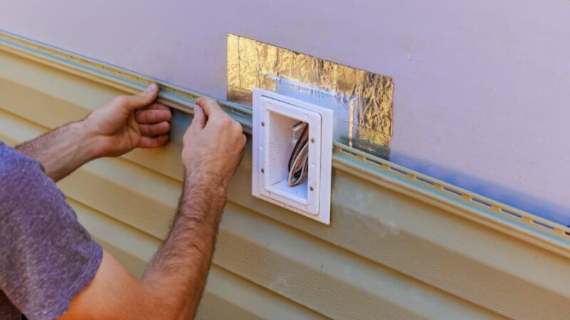 Professional siding contractor at work