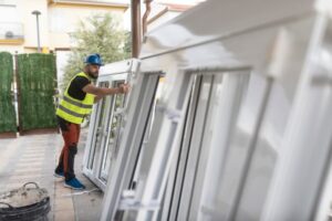 Worker preparing vinyl window frames