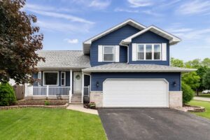Suburban home with blue siding and gray roof