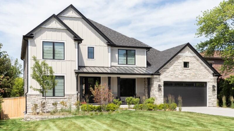 Modern tan farmhouse with board-and-batten siding