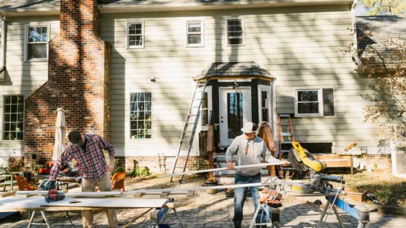 Professional contractors installing house siding