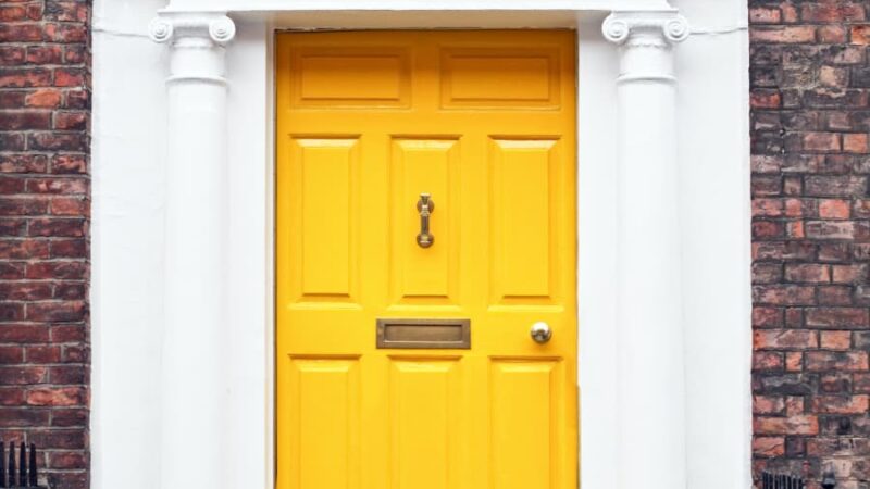 Yellow front door with arch overhead