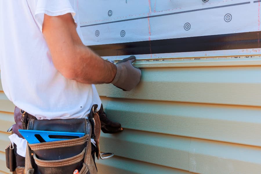 contractor-installing-siding-on-home Contractor installing siding on home